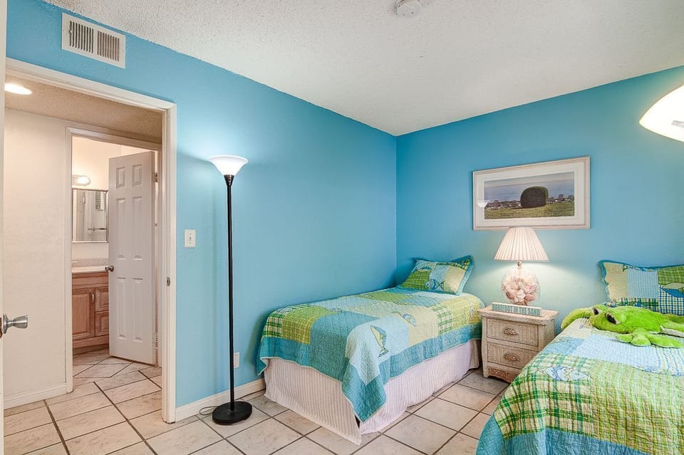 The guest bedroom includes two twin beds, with the bathroom located right across the hall..
                