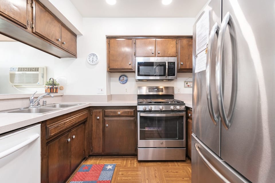 The kitchen comes stocked with dishes, utensils, glassware, bakeware, cookware, and large and small appliances.
                
