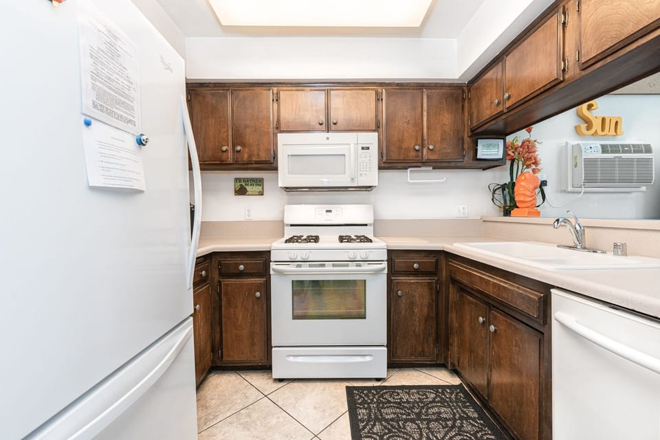 The kitchen comes stocked with dishes, utensils, glassware, bakeware, cookware, and large and small appliances.
                