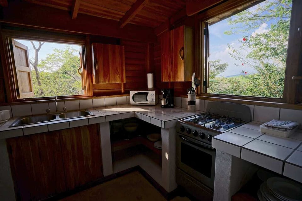 The bright kitchen and bar counter opening onto the living room veranda