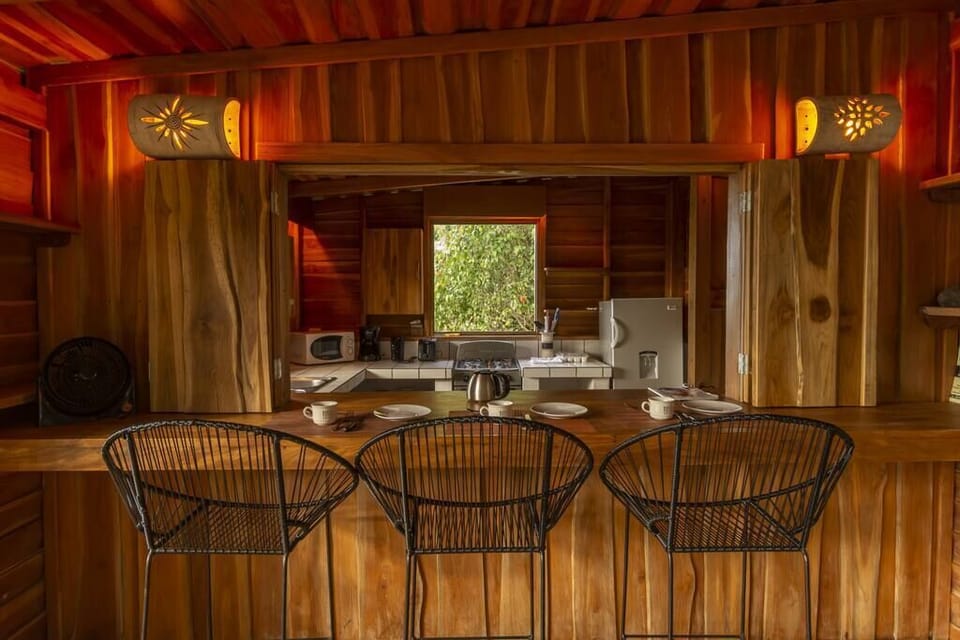 The bar seating and open kitchen allows for interaction between the cooks and company