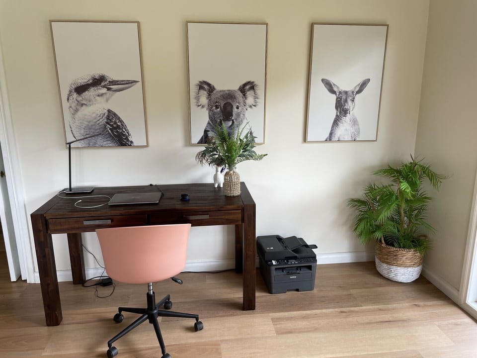 Office area with desk, printer, wireless charger and USB port