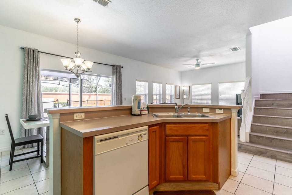Open ground floor space with kitchen, dining and living rooms all open to the private screened in lanai
