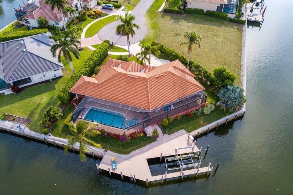The Mermaid Manor is situated at the end of a quiet cul de sac with stunning tropical landscaping and nearly 270 degrees of water views.