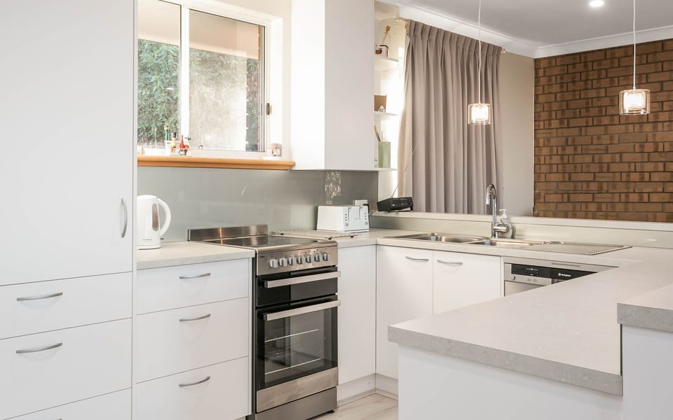New kitchen with dishwasher, oven, and Nespresso coffee machine