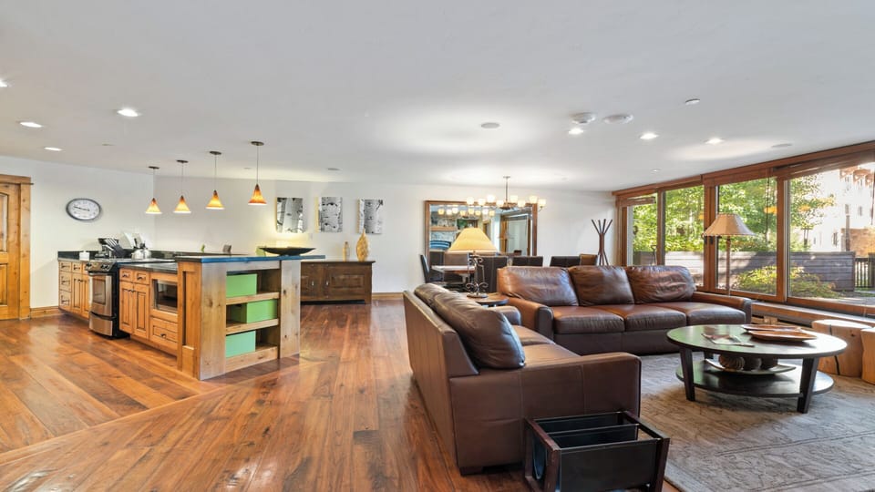 Unwind in your spacious open-concept living area, where rich wood floors and natural light create a warm, welcoming retreat perfect for gathering with loved ones.