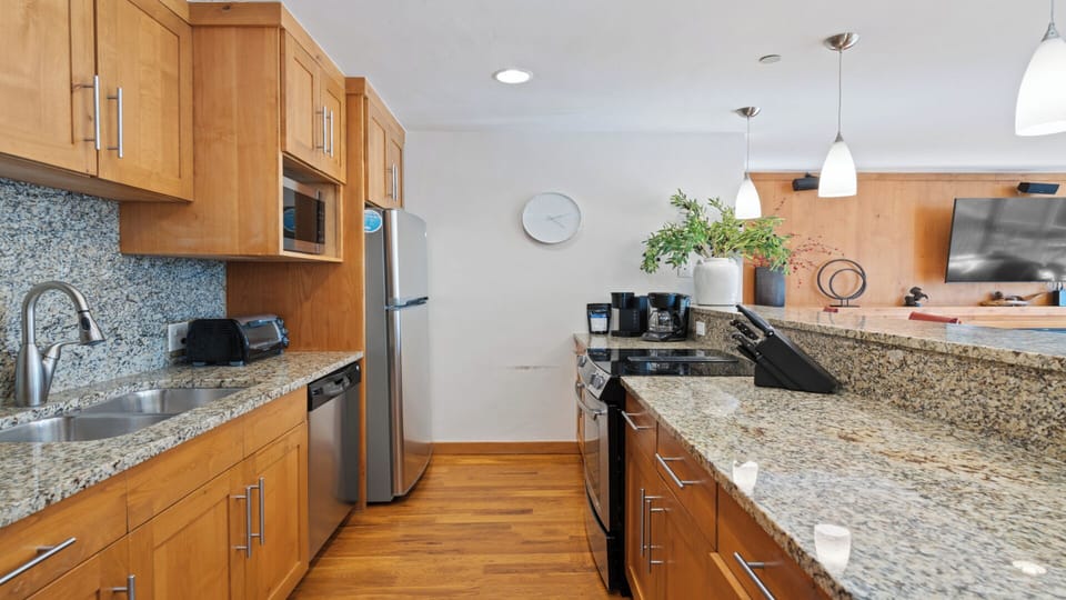 Your fully equipped kitchen invites you to whip up meals with ease. Enjoy granite countertops, stainless steel appliances, and warm wood floors that make cooking feel like home.
