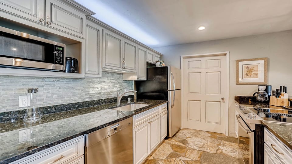 Your fully equipped kitchen features gleaming granite counters, stainless steel appliances, and plenty of cabinet space—everything you need to create your favorite meals in comfort.