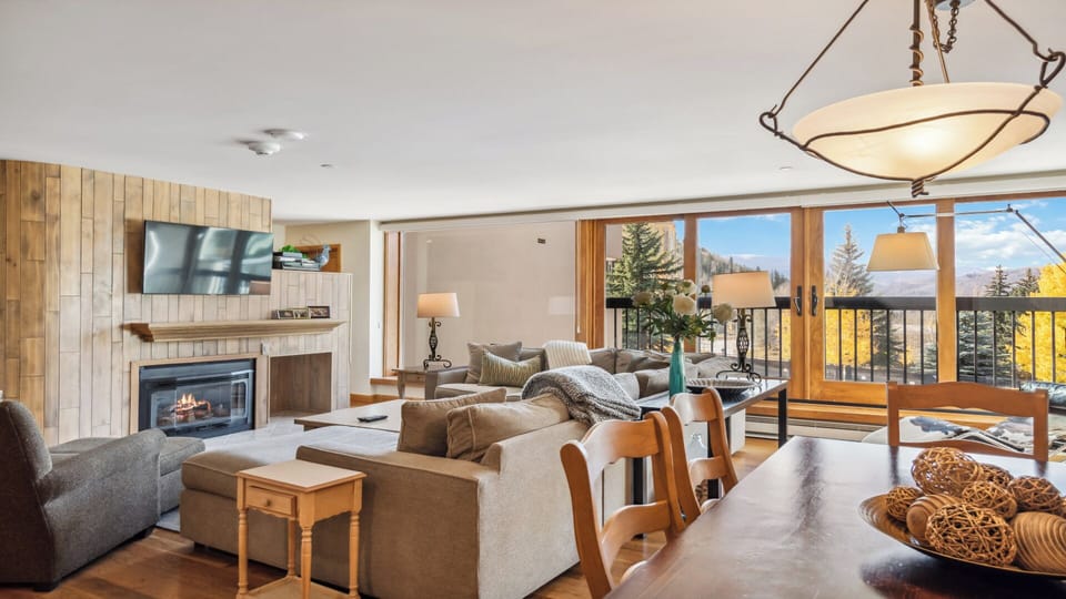 Unwind in this inviting living space where warmth meets mountain views. Your cozy fireplace, plush seating, and a sunlit balcony create the perfect retreat after a day of adventure.