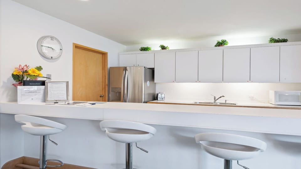 Your modern kitchen invites easy meal prep with sleek counters, stainless steel appliances, and casual breakfast bar seating for morning coffee and conversation.