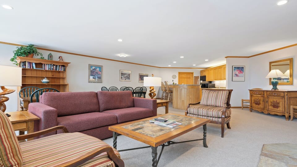 Relax in your spacious open-concept living area with cozy seating, dining for family meals, and a fully-equipped kitchen—everything you need for a memorable mountain getaway.
