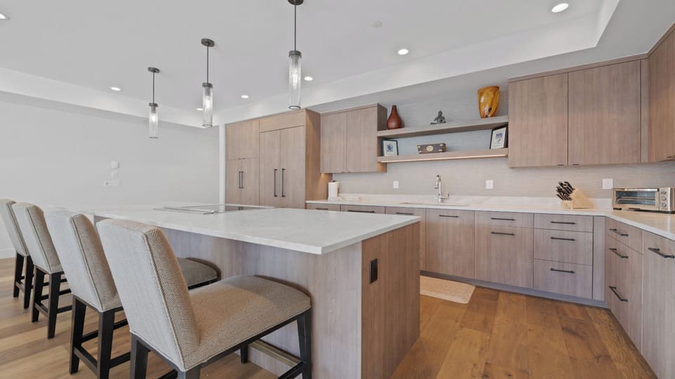 Gather around this sleek kitchen island, perfect for your morning coffee or prepping meals together. Warm wood tones and modern finishes create a space where functionality meets style, making you feel right at home.
