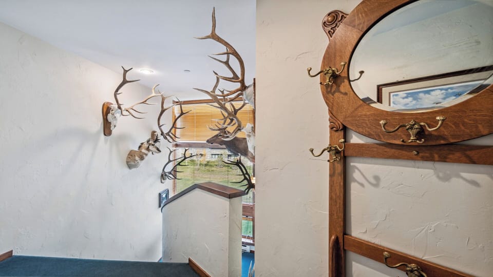 Rustic entryway featuring antler displays and warm wood accents that set a unique, outdoorsy tone as you arrive at this distinctive mountain-style retreat.