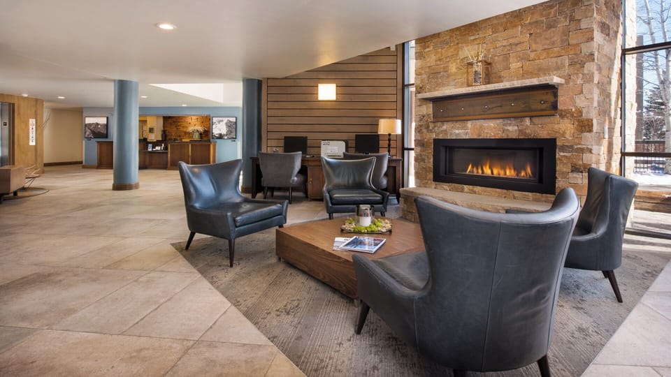 The lobby welcomes you with a striking stone fireplace, cozy leather seating, and warm wood accents—a perfect place to unwind after a day of adventure.