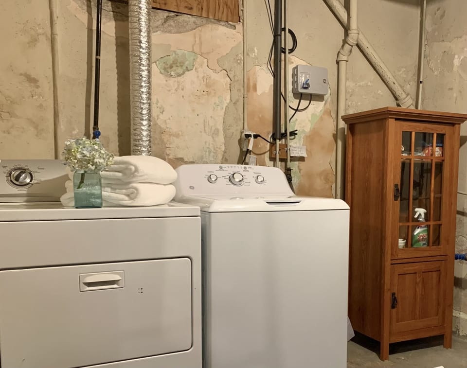 Washer and dryer with large folding table. We even provide laundry detergent! 