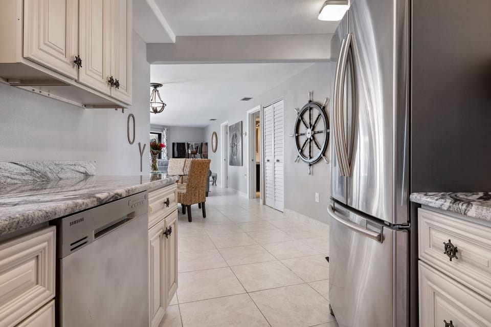 fully stocked kitchen with stainless steel appliances and granite countertops