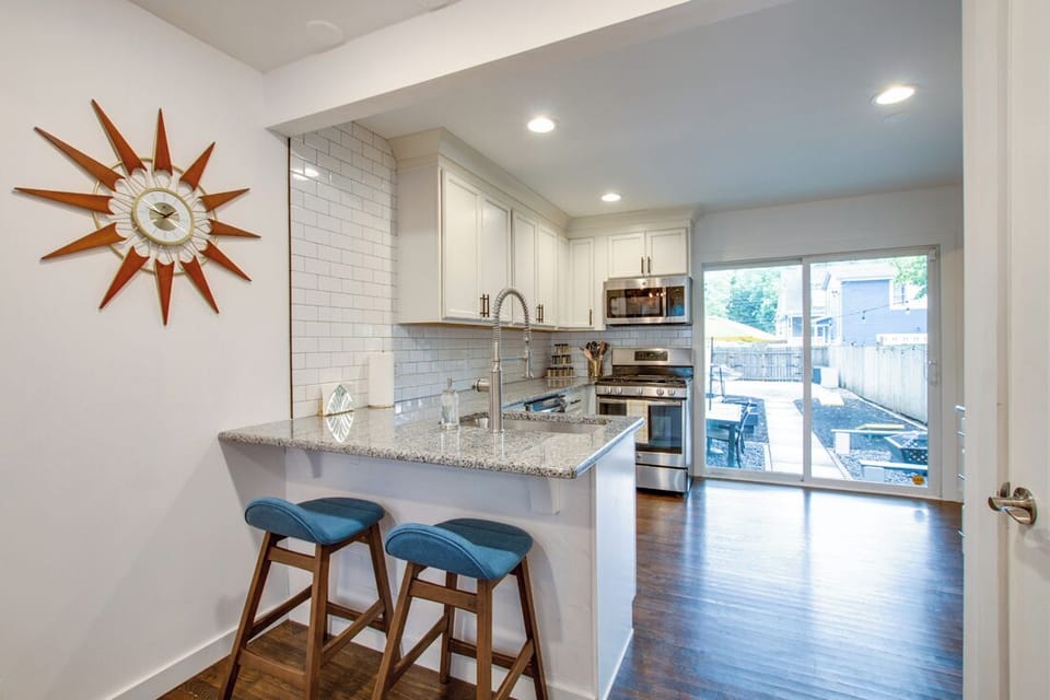 Bright fully equipped kitchen with lots of natural light leading out to patio
