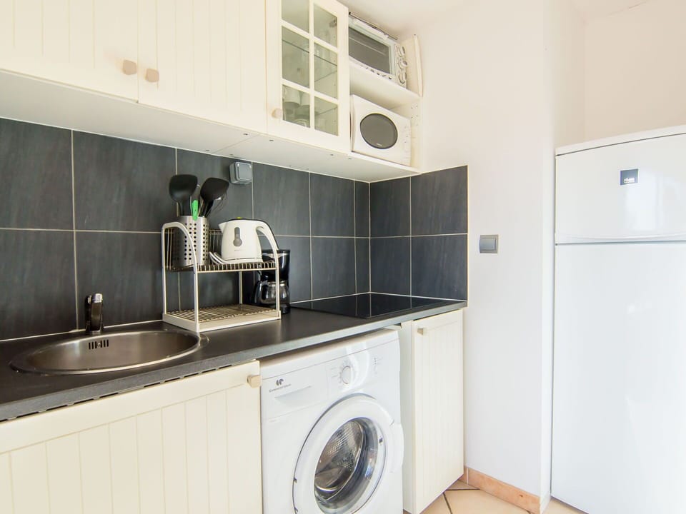 Kitchen Sink, Cabinetry, Property, Tap, Sink, Laundry Room, Countertop, Kitchen Appliance, Plumbing Fixture, Kitchen Stove
