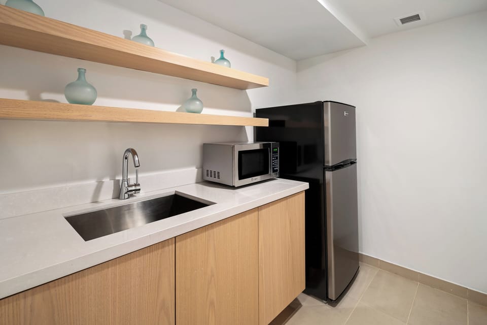 One Bedroom Suite King with Balcony | Private kitchenette | Espresso maker, coffee/tea maker, eco-friendly cleaning products