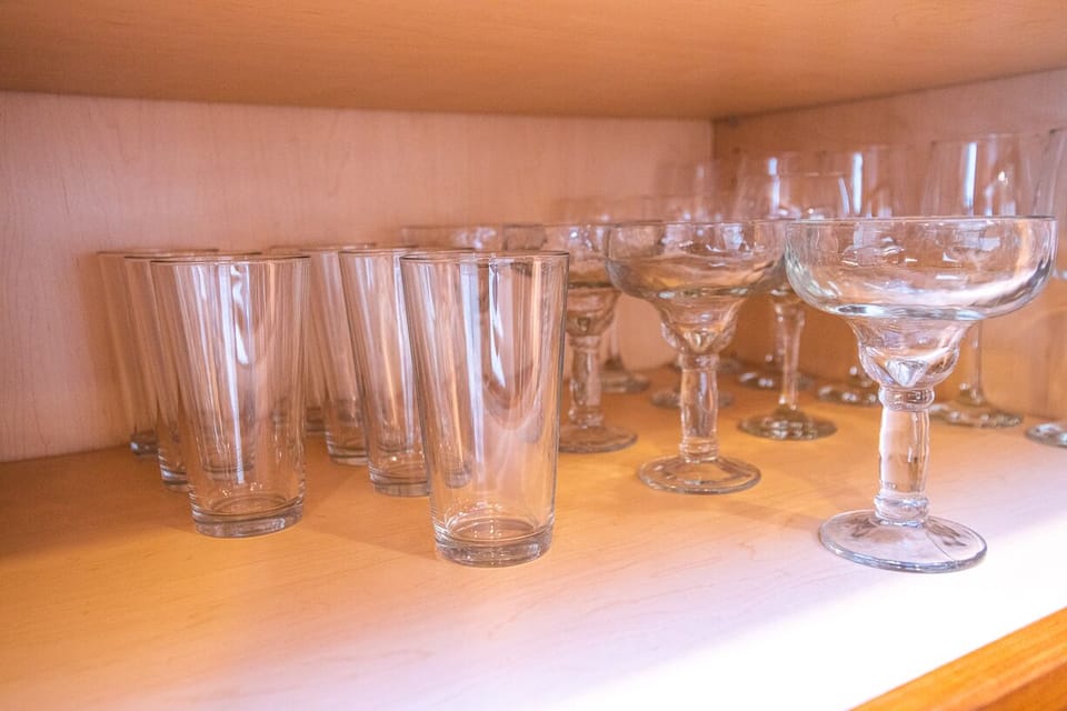 Beverage glasses are located in the buffet