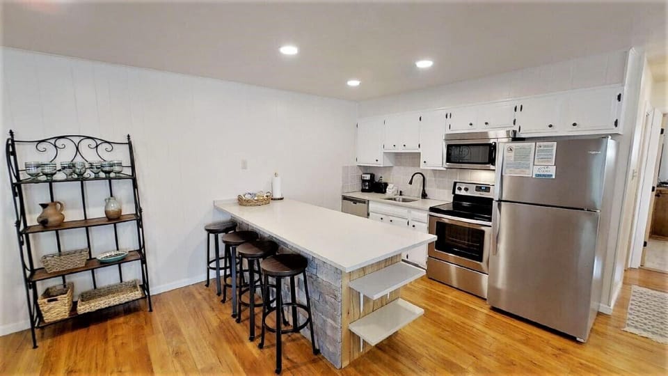 Your fully equipped kitchen invites you to whip up meals with stainless steel appliances, a spacious center island with seating, and plenty of counter space to gather and enjoy.