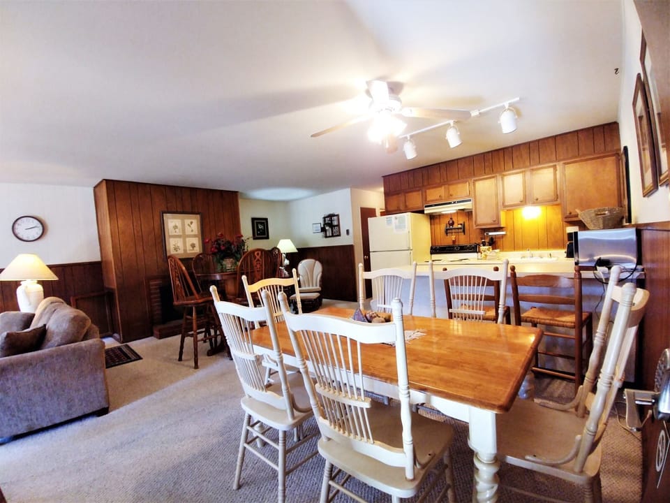 A welcoming open-concept space where your entire group can gather together, featuring a full kitchen, cozy dining area, and comfortable living room all in one inviting setting.
