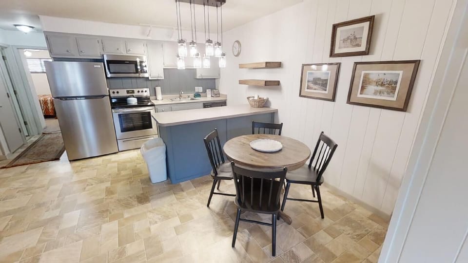 Your bright, fully-equipped kitchen features modern stainless steel appliances, ample counter space, and a cozy dining nook perfect for sharing meals with loved ones in rustic comfort.