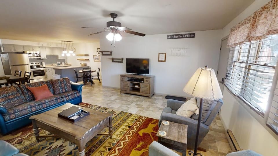 Settle into your spacious open-concept living area, where natural light fills the room and cozy furnishings invite you to relax, watch TV, or gather around for meals in the adjoining kitchen and dining space.
