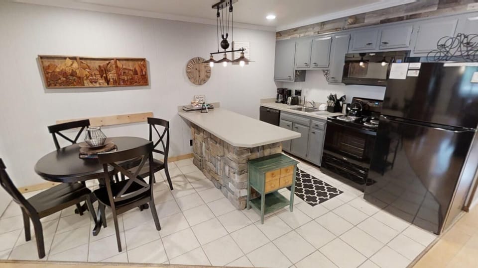 Your home away from home starts here—a fully equipped kitchen and cozy dining nook with rustic charm, perfect for preparing meals and gathering with loved ones.