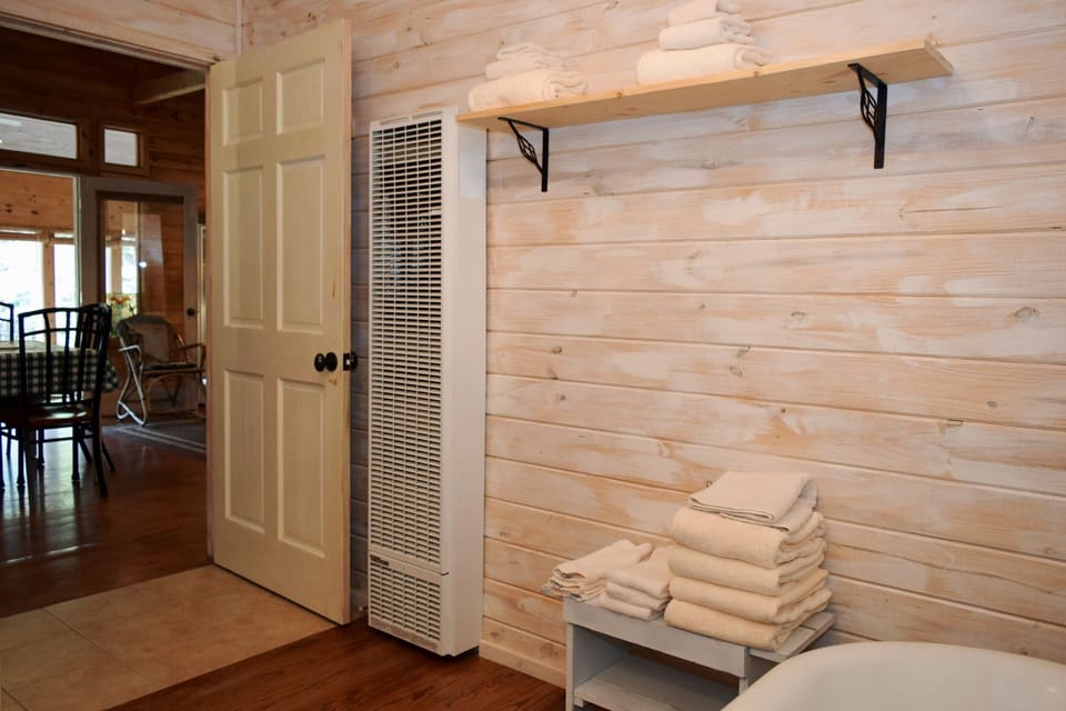 Cozy wood-paneled walls and fresh towels await your arrival. Step inside to discover a welcoming retreat designed for comfort and relaxation.