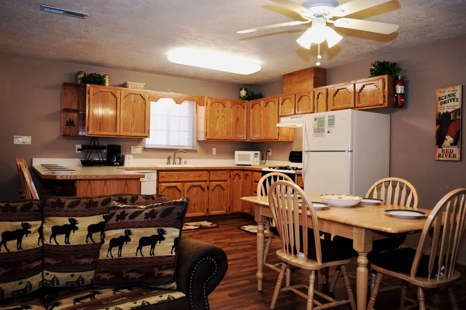 Your welcoming home base features an open living, dining, and fully-equipped kitchen perfect for family meals and cozy evenings. Warm wood tones and thoughtful touches create a relaxed mountain retreat atmosphere.