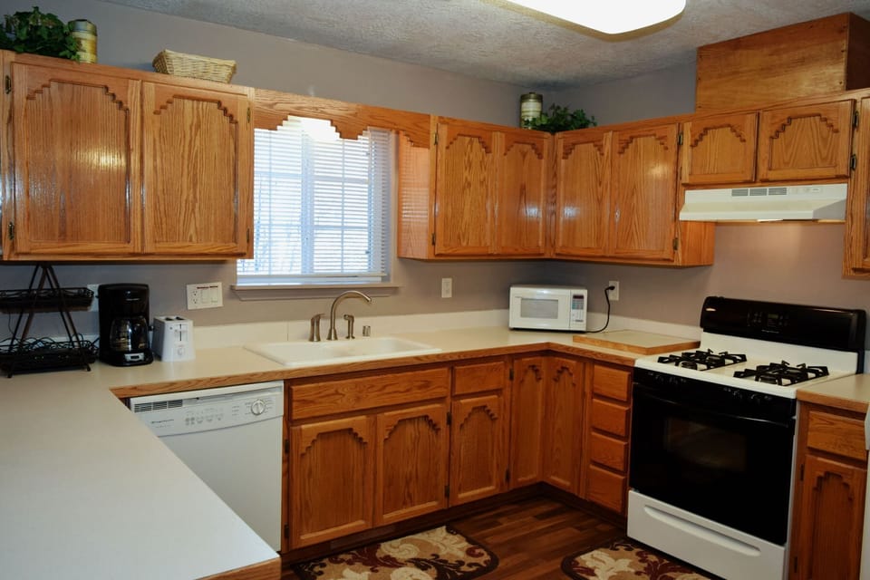 Cook your favorite meals in this fully equipped kitchen with ample cabinet space, modern appliances, and everything you need for a comfortable stay.