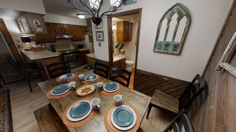 Your charming dining space awaits, thoughtfully set with rustic charm and an inviting table ready for memorable meals with loved ones.