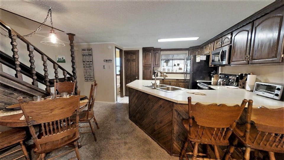 Step into your home-away-from-home kitchen and dining area, where rustic charm meets modern comfort. Gather around the farmhouse table, prep meals at the spacious island, and make lasting memories in this cozy space.