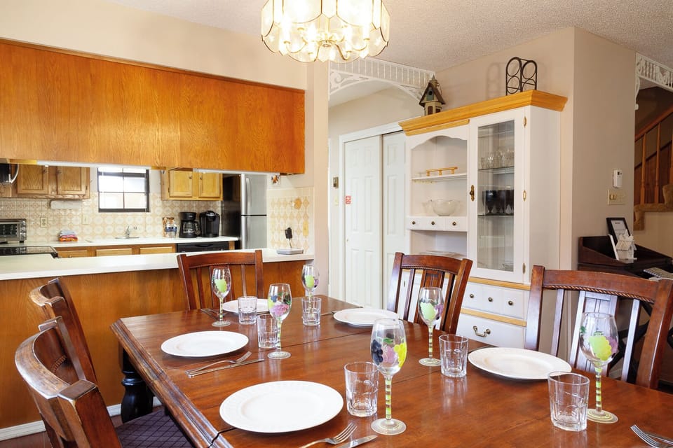 Step into your fully-equipped dining space where home-cooked meals become treasured memories around this inviting table set for six, seamlessly connected to your complete kitchen.
