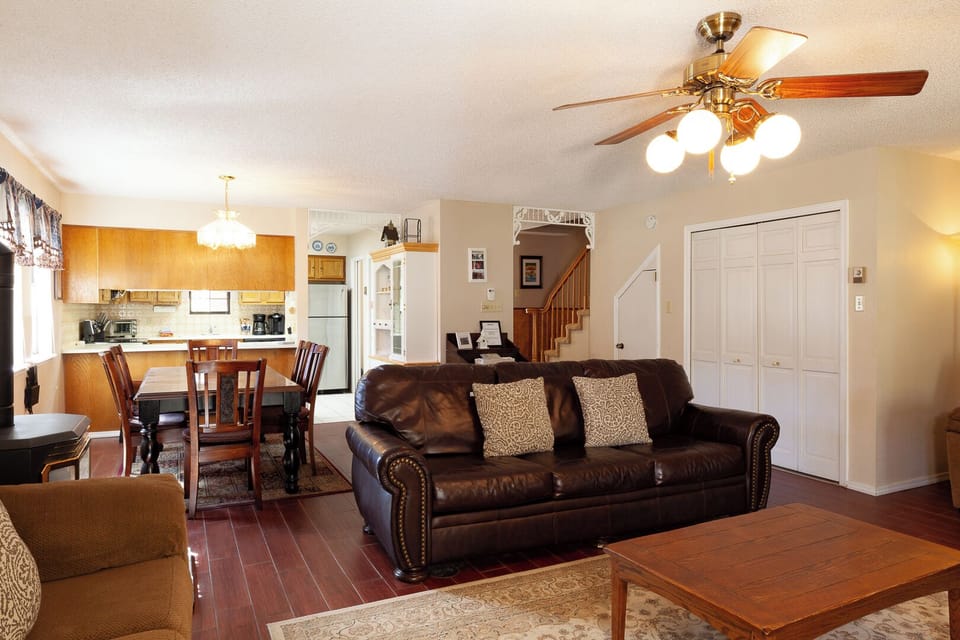 Step into your spacious open-plan retreat where comfort meets convenience. Relax on the plush leather sofa, gather around the dining table, or whip up meals in your fully-equipped kitchen—all beneath the warm glow of the ceiling fan.