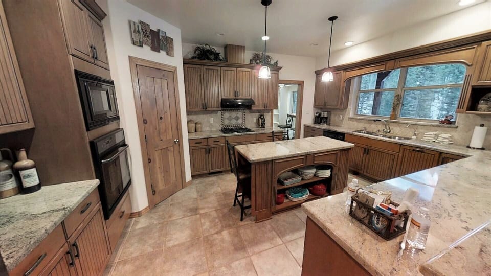 Your fully-equipped gourmet kitchen features granite countertops, double ovens, a central island, and everything you need to prepare delicious home-cooked meals during your stay.