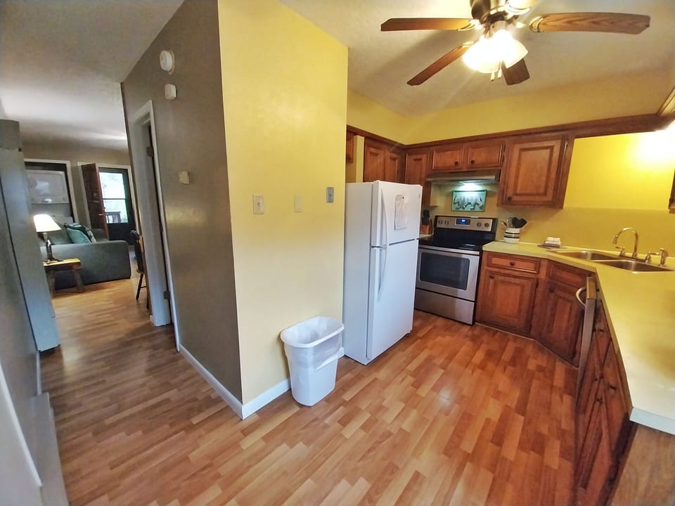 Your fully equipped kitchen awaits with warm wood cabinetry, modern appliances, and plenty of counter space for preparing home-cooked meals during your stay.