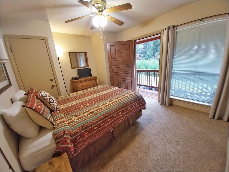 Wake up to natural light and gentle breezes from your private balcony. This cozy bedroom blends warmth and comfort, inviting you to unwind beneath the ceiling fan after a day of adventure.