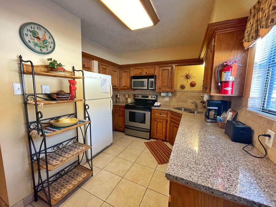 Your fully equipped kitchen features warm wood cabinetry, granite countertops, and all the appliances you'll need to whip up a homemade meal during your getaway.