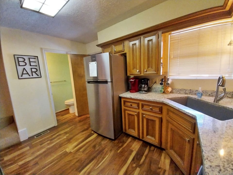 Your fully equipped kitchen features granite countertops, stainless steel appliances, and warm wood cabinetry—everything you need to whip up your favorite meals or morning coffee during your stay.