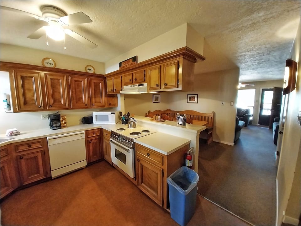Your fully equipped kitchen features warm wood cabinetry, modern appliances, and everything you need to prepare meals during your stay. The adjoining dining nook offers a cozy spot for casual gatherings.