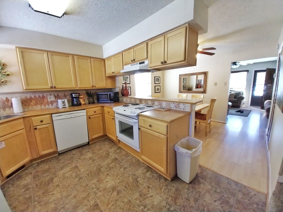 Prepare your favorite meals in this fully equipped kitchen with plenty of counter space, modern appliances, and a cozy breakfast nook for enjoying morning coffee.