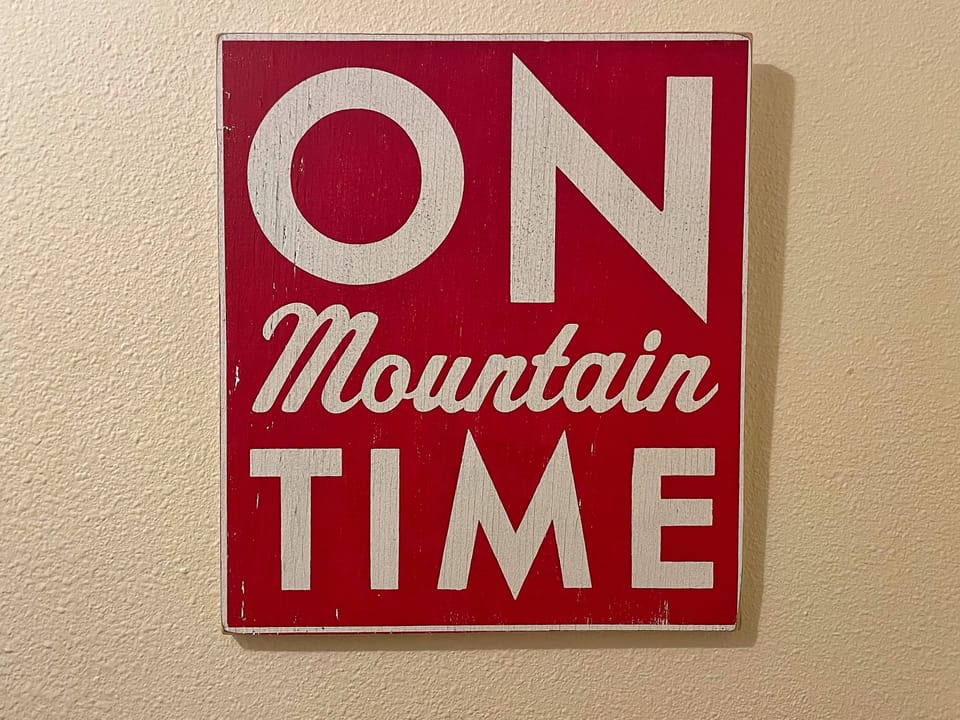 Vintage-inspired signage referencing the property's mountain setting and relaxed pace of life.