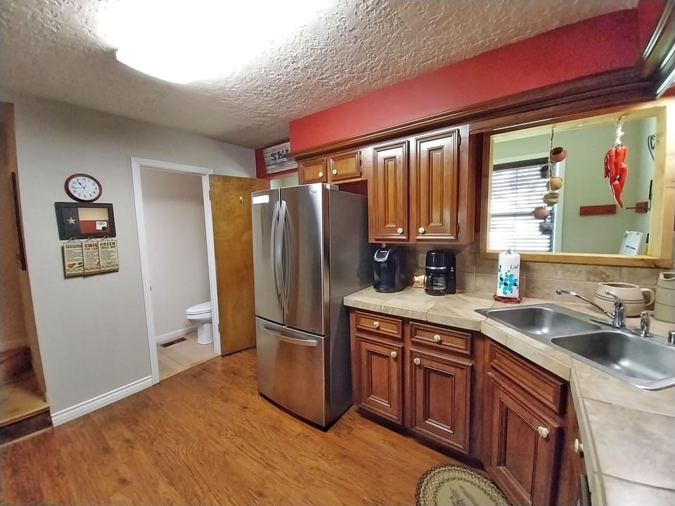 Your fully equipped kitchen features rich wood cabinetry, modern stainless steel appliances, and ample counter space for preparing delicious home-cooked meals during your stay.