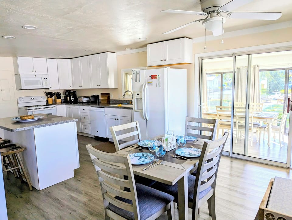 38166 Bow Street, Ocean View - dining area - Light-filled dining nook with a wooden table set, stylish pendant lighting, and views into the main living space.