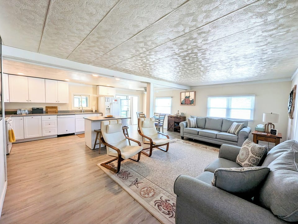 38166 Bow Street, Ocean View - open concept - Wide-angle view showcasing the seamless flow between the living room, dining area, and kitchen, perfect for entertaining.