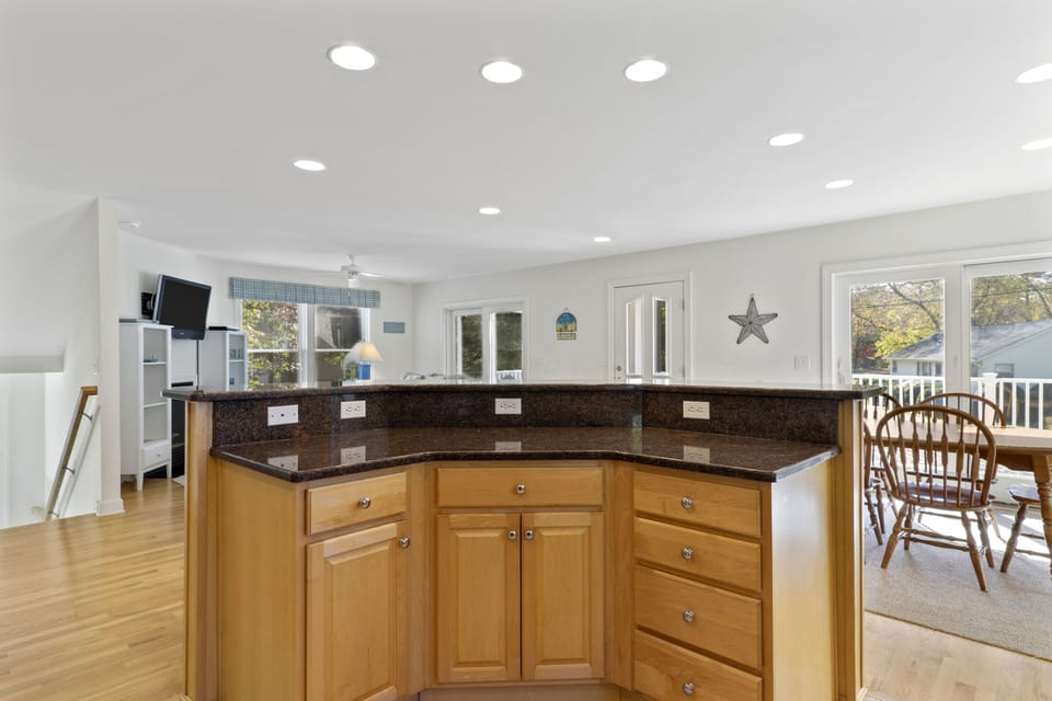 511 Doral Drive - Kitchen Island - Functional kitchen layout with a convenient breakfast bar, providing extra seating and a great spot for casual morning coffee.