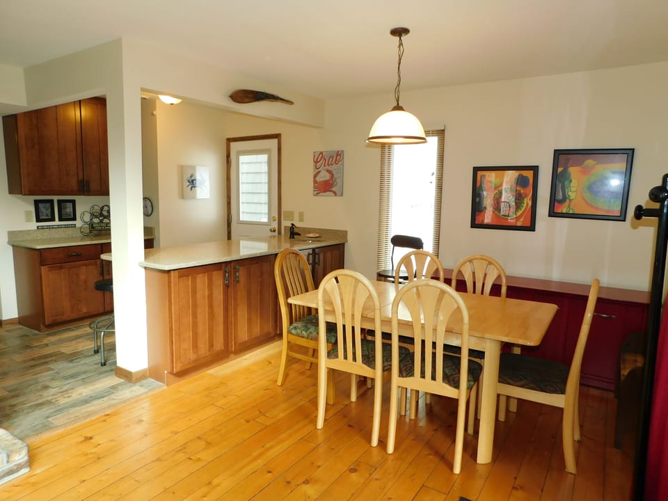 612 Paget Court - Formal Dining Space - Situated between the kitchen and living area, the dining space features a large wooden table and updated cabinetry. The open-flow design is ideal for hosting family dinners and entertaining guests.
