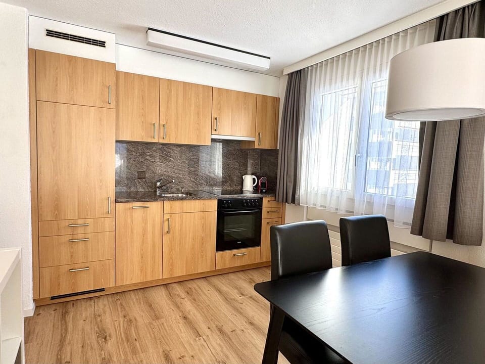 Furniture, Interior Design, Flooring, Wood, Floor, Countertop, Cabinetry, Room, Lighting, Kitchen